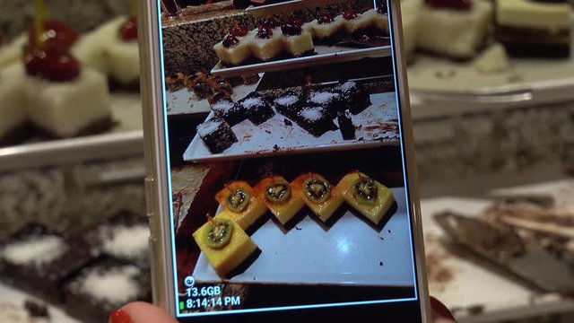 The sequence of images of food photo. A person photographs various desserts and sweets in a buffet restaurant.