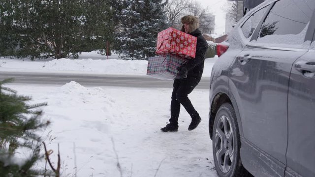 Man slips on ice carrying Christmas gifts