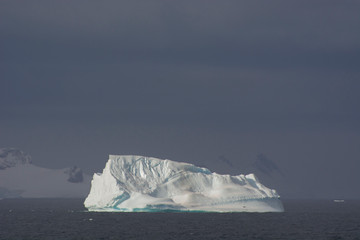Antarctica. Gerlache Strait. Iceberg with a seal resting on it.