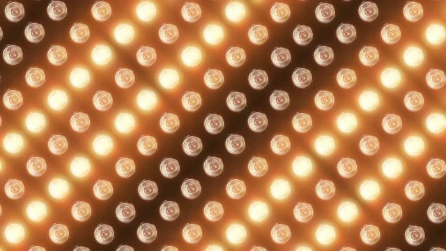 Wall of flashing lights and bright spotlights. Looped animations with glow and lens effects. Ideal background for video and music videos, for vibrant dynamic designs of composition from light
