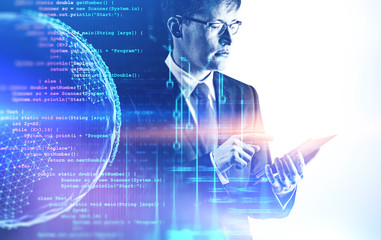 Serious man with tablet, code and planet