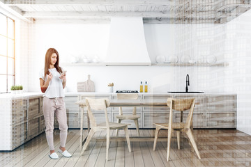 Fototapeta na wymiar Woman in white kitchen with table