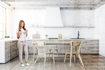 Woman in white kitchen with table