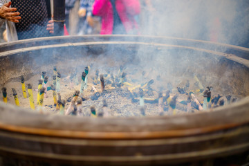 Smoke from many burning incense in giant incense burner,In front of famous Buddhist temple Senso-ji in Asakusa, Japan.