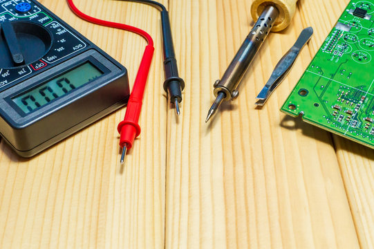 Services for the production of electronics and repair on a wooden background.