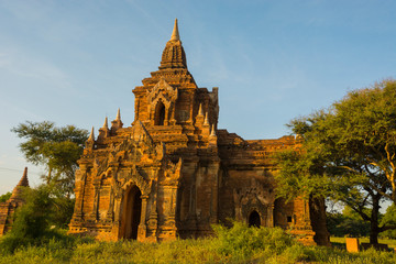 Myanmar. Bagan. Red brick temple glows in the late afternoon light.