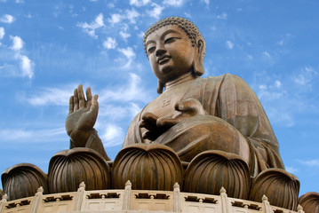 Asia, China, Hong Kong, Lantau Island, Ngong Ping. The giant bronze Tian Tan Buddha statue sits on a lotus throne.