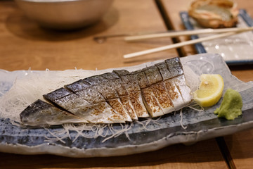 Japanese food style , Saba fish grilled. in dish on wood table. Traditional menu of Japan.