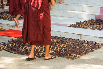 Myanmar. Mandalay. Maha Aung Myae Bone San Monastery. Novice monks carefully line up their shoes on...