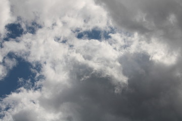 white cloud cover with a bit of blue sky