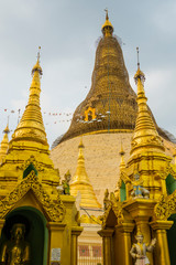 Fototapeta premium Myanmar. Yangon. Shwedagon Pagoda. Bamboo scaffolding surrounds the stupa so that new gold leaf can be applied.