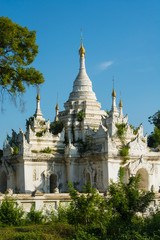 Fototapeta na wymiar Myanmar. Mandalay. Inwa. White temple surrounded by greenery.