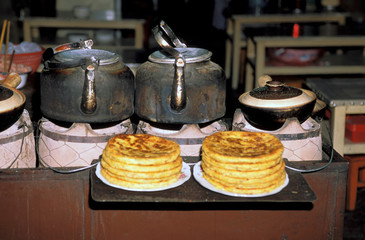 Asia, China, Lijiang. Tea and baba bread available on streetside.