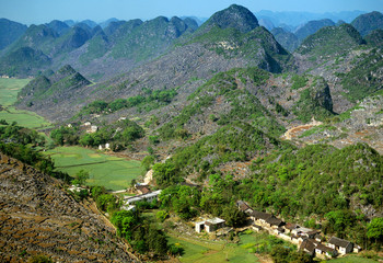 Fototapeta na wymiar Asia, China, Guizhou Province, Xingyi. Limestone karst mountains surround farm fields.
