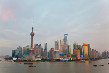 Naklejka premium Barges and Pudong skyline, sunset, Shanghai, China