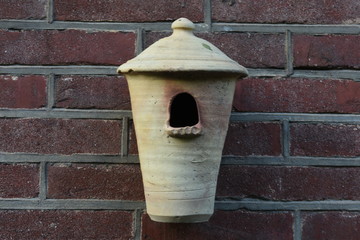birdhouse of stone in the city garden
