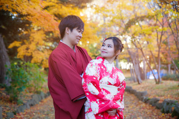 Young couple in love outdoor. Stunning sensual outdoor portrait of lover wearing japanese traditional kimono in autumn. love, relationship, season, family and people concept.