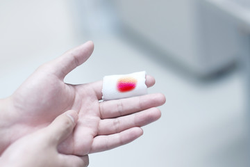 Bleeding on white gauze from forefinger wound
