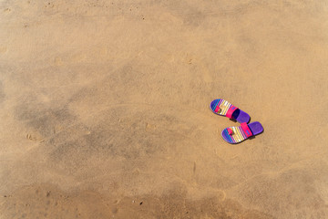 Fototapeta na wymiar women's shoes on the sand beach