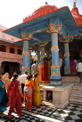 India, Rajasthan, Pushkar. Pilgrims at the pillared outdoor hall of the Brahma Temple in Pushkar.
