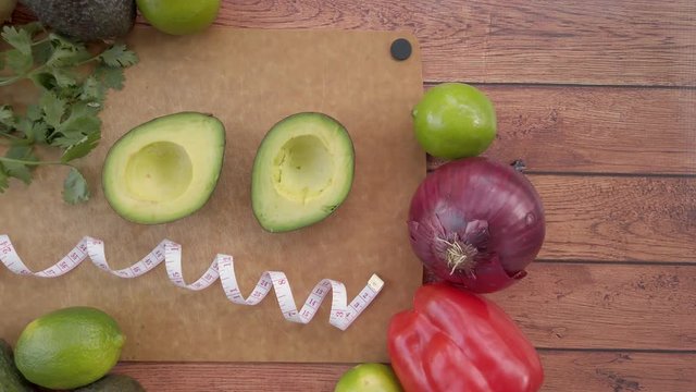 Panning across fresh sliced, avocados on a cutting board with tape measure.