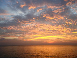 Naklejka na ściany i meble Amazing sunset on the sea in bright orange tones.
