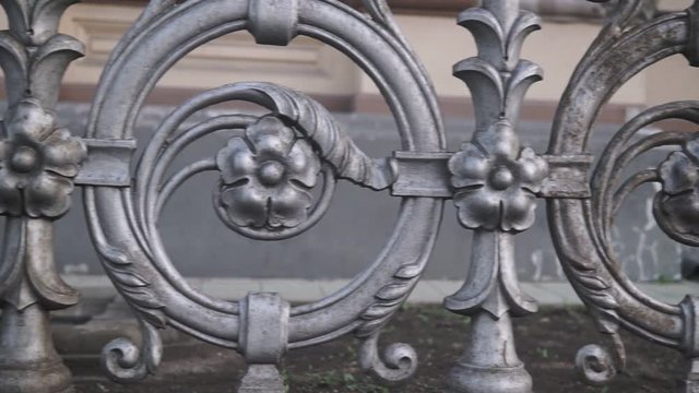 Forged fence close-up slow pan shot.