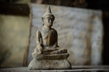 Laos, Luang Prabang. Tiny Buddha statue (in Buddha Cave).