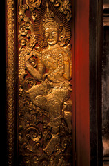 Fototapeta na wymiar Asia, Laos, Luang Prabang. Wat Xieng Thong, gilt panels from Ramayana.