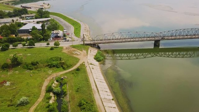 Aerial Drone Flight: View of the bridge over the river with cars. Olt river, Romania