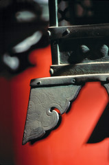 Japan, Nara Pref., Nara. The carved detail of a metal lantern plays against a red background in the Kasuga Shrine, Nara, Japan.