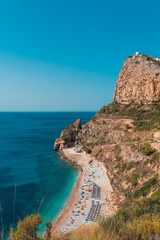 Fototapeta na wymiar op view of people at colorful and picturesque Beach lagoon with turquoise water in Javea , Alicante, Spain. Costa Blanca.