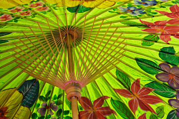 Fototapeta na wymiar Underside details of decorative hand painted umbrella drying after painting, Bo Sang, near Chiang Mai, Thailand