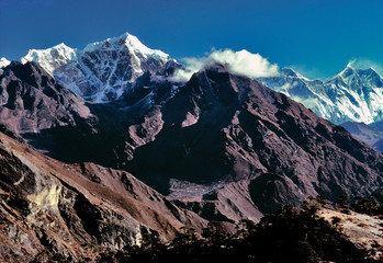 Asia, Nepal, Sagarmatha NP. Tawache Peak, left of center, and Mt. Everest, Lhotse and Nuptse to the right of the cloud bank, straddle the Nepal-Tibet border. - obrazy, fototapety, plakaty