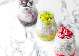 Chia pudding with berries ,raspberry sauce,kiwi sauce,blackberry sauce and frozen raspberries and blackberries and kiwi slices, healthy breakfast, vitamin snack, diet and healthy eating