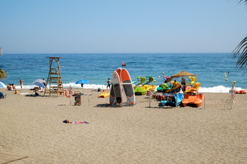 people at the beach with palm trees on the shore of the Mediterranean Sea