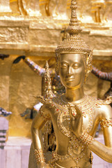 Thailand, Bangkok. Gold statue at Wat Phra Kaew Temple near Grand Palace.