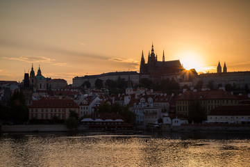 Fototapeta premium View of the Vltava River, Mala Strana district, St. Vitus Cathedral and Prague (Hradcany) Castle in Prague, Czech Republic, at sunset.
