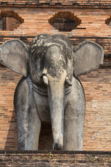 Thailand, Chiang Mai, Wat Chedi Luang. Elephant statues around temple exterior.