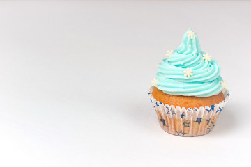 Cupcake decorated with sugar snowflakes and blue cream.Christmas winter cupcakes