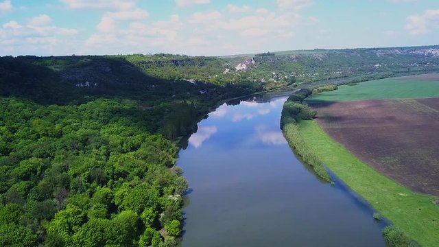 Flight over the river and forest at spring time. Dniester river of Moldova republic.