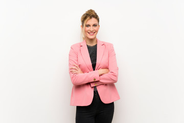 Young blonde woman with pink suit keeping the arms crossed in frontal position