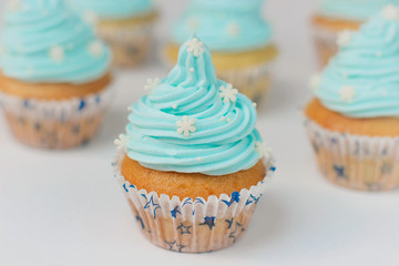 Cupcake decorated with sugar snowflakes and blue cream.Christmas winter cupcakes