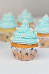Cupcake decorated with sugar snowflakes and blue cream.Christmas cupcakes