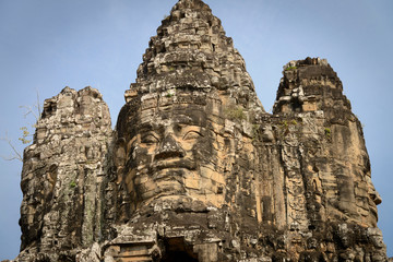 Fototapeta na wymiar Cambodia, Angkor Wat. Entry gate to Angkor Thom. Face of the benevolent Bodhisattva, Lokesvara.