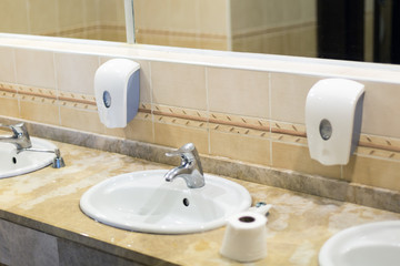 Clean toilet room in the hotel. Washbasin washbasin faucet with water and liquid soap in the hotel toilet.
