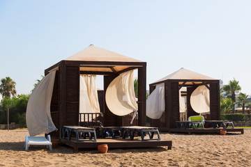 A tent place under a canopy for a cozy luxurious holiday by the sea.  Exclusive beach holiday destination.
