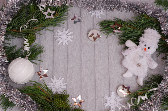 Christmas and New Year composition with copy space on a gray background from branches, Christmas balls, tinse