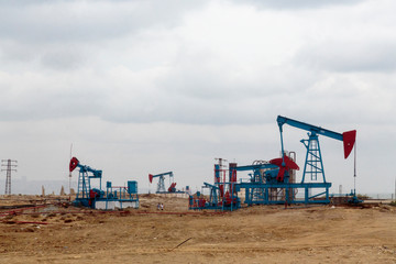 Fototapeta na wymiar Azerbaijan, Baku. Oil pumpjacks in the badlands outside of Baku.