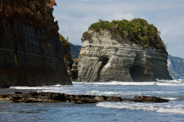 South Pacific, New Zealand, North Island. View of Elephant Rock and its arch. 